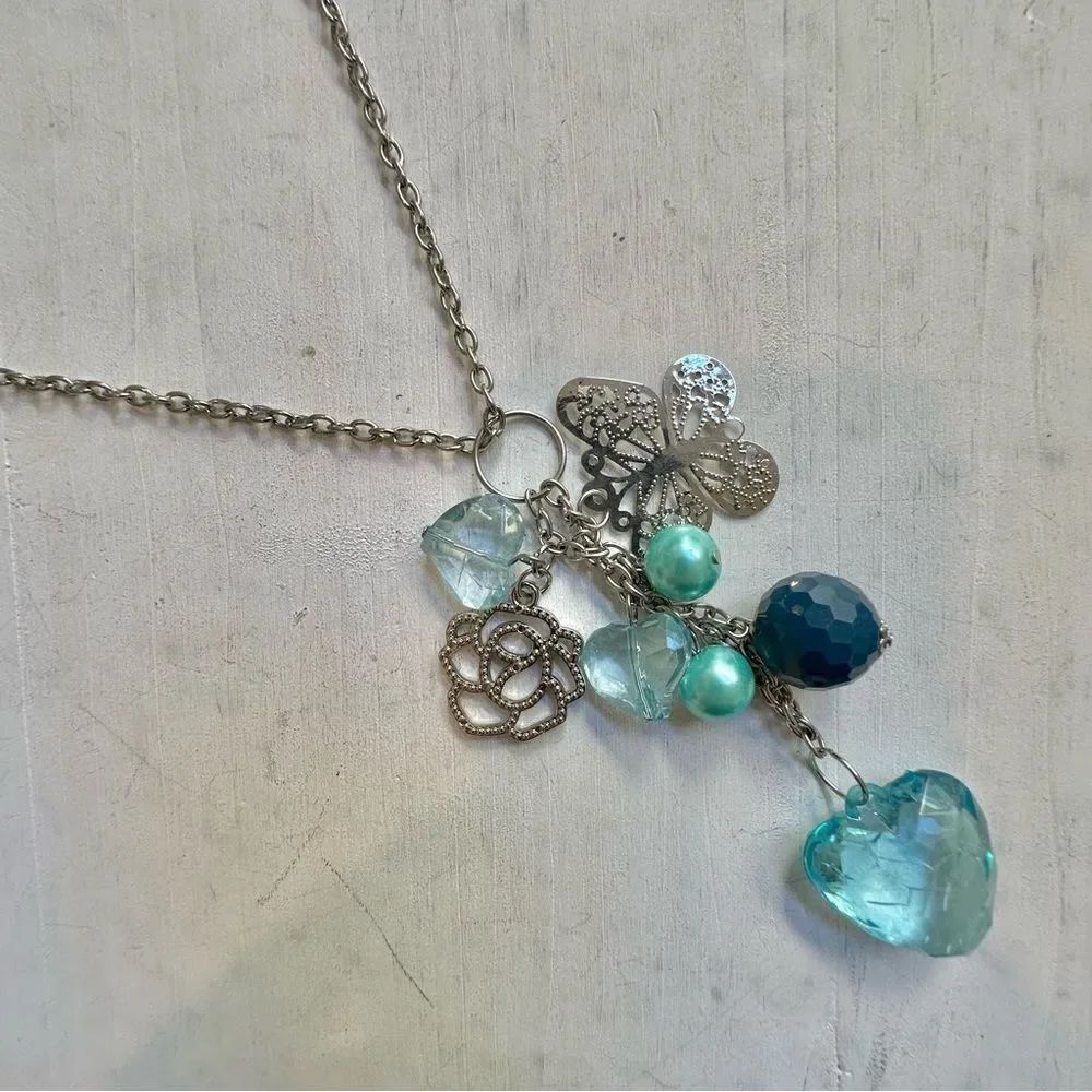 Long silver tone blue charm necklace